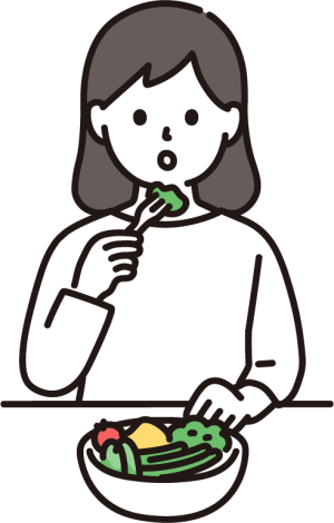野菜を食べる女性。バランスを意識した食事のイメージ